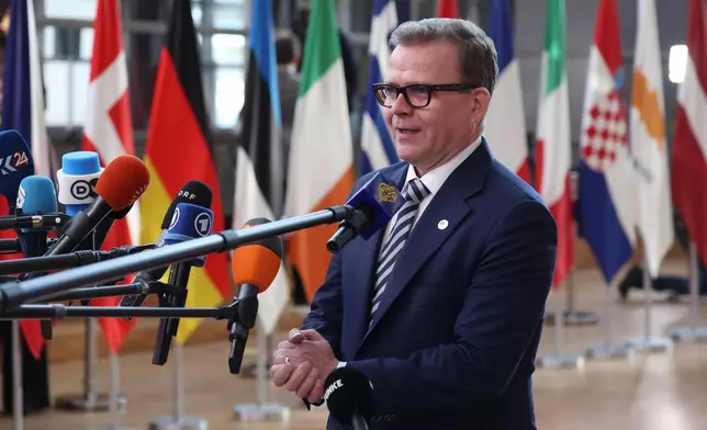 Finland's Prime Minister Petteri Orpo speaks with the media as he arrives for the EU summit at the European Council building in Brussels, Thursday, March 19, 2026. (AP Photo/Omar Havana)