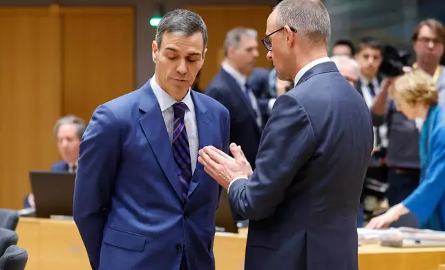 Germany's Chancellor Friedrich Merz, right, speaks with Spain's Prime Minister Pedro Sanchez during a round table meeting at the EU summit in Brussels, Thursday, March 19, 2026. (AP Photo/Geert Vanden Wijngaert)
