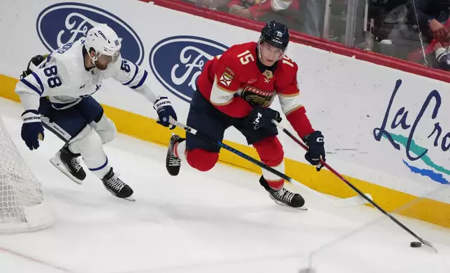 Florida Panthers center Anton Lundell (15) skates with the puck as Toronto Maple Leafs right wing William Nylander (88) defends during the third period of an NHL hockey game, Thursday, Feb. 26, 2026, in Sunrise, Fla. (AP Photo/Lynne Sladky)