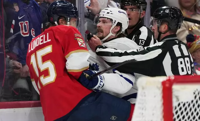 Florida Panthers center Anton Lundell (15) and Toronto Maple Leafs defenseman Oliver Ekman-Larsson, right, scuffle during the second period of an NHL hockey game, Thursday, Feb. 26, 2026, in Sunrise, Fla. (AP Photo/Lynne Sladky)