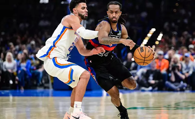 Detroit Pistons guard Daniss Jenkins (24) drives against Oklahoma City Thunder guard guard Ajay Mitchell (25) during the first half of an NBA basketball game Monday, March. 30, 2026, in Oklahoma City. (AP Photo/Gerald Leong)