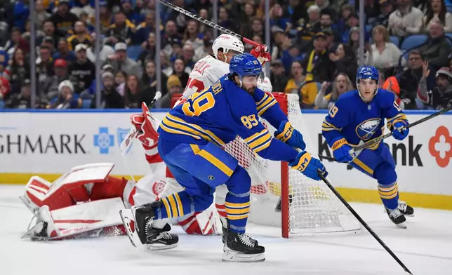 Buffalo Sabres right wing Alex Tuch (89) reaches for the puck during the first period of an NHL hockey game against the Detroit Red Wings, Friday, March 27, 2026, in Buffalo, N.Y. (AP Photo/Adrian Kraus)