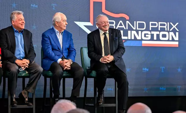 FILE -Texas Rangers chief operating officer Neil Leibman, left, Penske corporation chairman Roger Penske, center, and Dallas Cowboys team owner Jerry Jones, right, attend a news conference in Arlington, Texas, Tuesday, Oct. 8, 2024, announcing the IndyCar Grand Prix of Arlington to be held in 2026. (AP Photo/Jerome Miron, File)