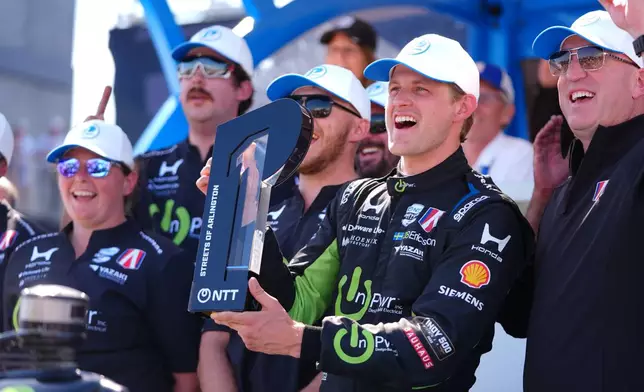 Driver Marcus Ericsson holds the pole position trophy for the IndyCar Grand Prix of Arlington auto race, Saturday, March 14, 2026, in Arlington, Texas. (AP Photo/LM Otero)