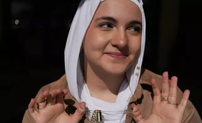 Haneen Alatiyat, a member of the Islamic Center of Passaic County in Paterson, N.J., poses for a portrait at the mosque's entrance during Ramadan on Friday, Feb. 27, 2026. (AP Photo/Luis Andres Henao)