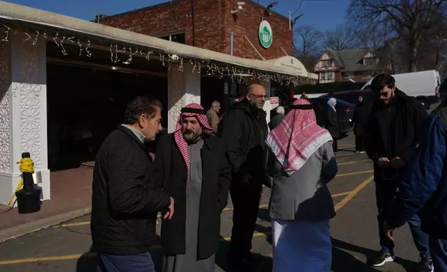 Congregants greet each other during Ramadan after attending prayers at the Islamic Center of Passaic County in Paterson, N.J., on Friday, Feb. 27, 2026. (AP Photo/Luis Andres Henao)