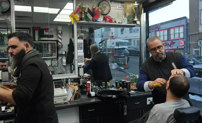 Raed Odeh, the owner and top barber of the Palestine Hair Salon shaves a man in Paterson, N.J., during Ramadan on Friday, Feb. 27, 2026. (AP Photo/Luis Andres Henao)