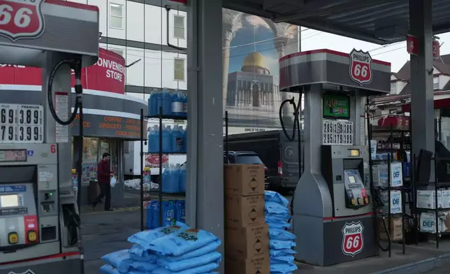 A gas station in Paterson, N.J., is seen near a mural-sized image of the Dome of the Rock shrine at the Al-Aqsa Mosque compound in Jerusalem's Old City during Ramadan on Friday, Feb. 27, 2026. (AP Photo/Luis Andres Henao)