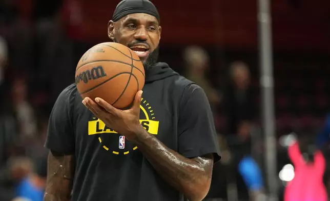 Los Angeles Lakers forward LeBron James warms up before an NBA basketball game against the Miami Heat, Thursday, March 19, 2026, in Miami. (AP Photo/Lynne Sladky)