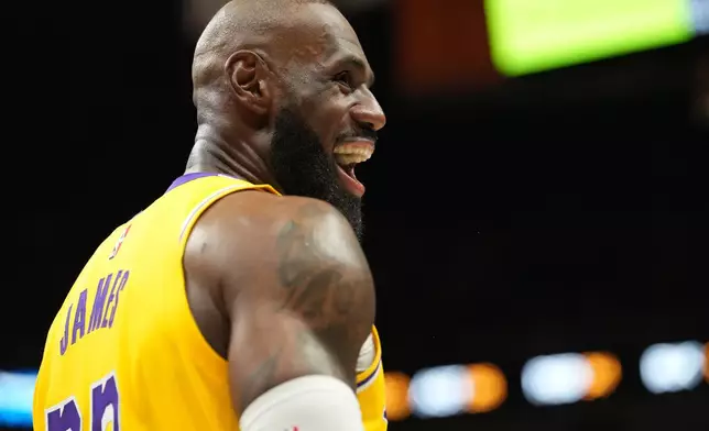 Los Angeles Lakers forward LeBron James smiles during the second half of an NBA basketball game against the Miami Heat, Thursday, March 19, 2026, in Miami. (AP Photo/Lynne Sladky)