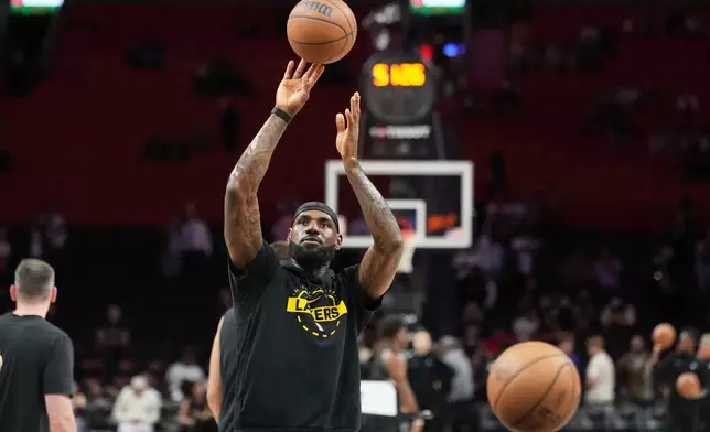 Los Angeles Lakers forward LeBron James warms up before an NBA basketball game against the Miami Heat, Thursday, March 19, 2026, in Miami. (AP Photo/Lynne Sladky)