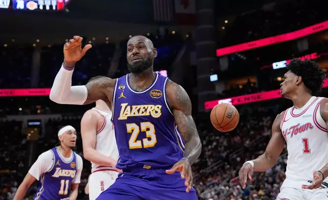 Los Angeles Lakers' LeBron James (23) reacts after a dunk against the Houston Rockets during the second half of an NBA basketball game Wednesday, March 18, 2026, in Houston. (AP Photo/David J. Phillip)