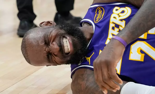 Los Angeles Lakers' LeBron James reacts after hitting the court while being fouled by Houston Rockets' Jabari Smith Jr. during the second half of an NBA basketball game Wednesday, March 18, 2026, in Houston. (AP Photo/David J. Phillip)