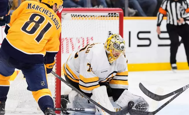 Boston Bruins goaltender Joonas Korpisalo (70) blocks a shot on goal by Nashville Predators center Jonathan Marchessault (81) during the second period of an NHL hockey game Thursday, March 5, 2026, in Nashville, Tenn. (AP Photo/George Walker IV)