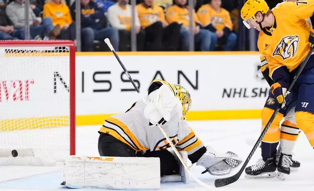 Nashville Predators right wing Matthew Wood, right, scores a goal past Boston Bruins goaltender Joonas Korpisalo (70) during the second period of an NHL hockey game Thursday, March 5, 2026, in Nashville, Tenn. (AP Photo/George Walker IV)