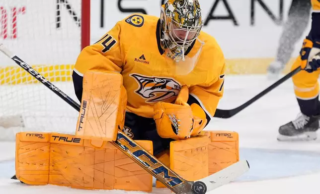 Nashville Predators goaltender Juuse Saros (74) blocks a shot on goal during the first period of an NHL hockey game against the Boston Bruins, Thursday, March 5, 2026, in Nashville, Tenn. (AP Photo/George Walker IV)