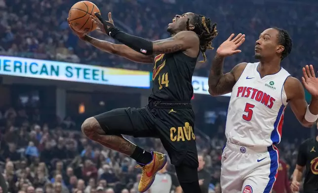 Cleveland Cavaliers guard Keon Ellis (14) goes to the basket past Detroit Pistons forward Ronald Holland II (5) in the first half of an NBA basketball game in Cleveland, Tuesday, March 3, 2026. (AP Photo/Sue Ogrocki)