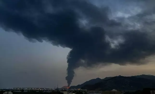 FILE - Fire and a plume of smoke is visible after, according to authorities, debris of an Iranian intercepted drone hit the Fujairah oil facility, in Fujairah, United Arab Emirates, March 3, 2026. (AP Photo/Altaf Qadri)