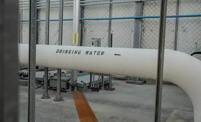 FILE - A pipe carrying drinking water runs through the Carlsbad desalination plant in Carlsbad, Calif., Dec. 2, 2025. (AP Photo/Annika Hammerschlag, File)