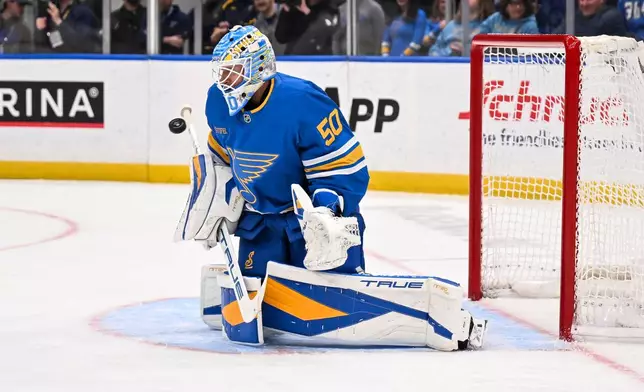 St. Louis Blues' Jordan Binnington (50) makes a save during the third period of an NHL hockey game against the Toronto Maple Leafs' Saturday, March 28, 2026, in St. Louis. (AP Photo/Connor Hamilton)