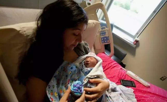 In this photo provided by Andrea Lopez, she cradles her son, Gabriel Cude, at a hospital Bakersfield, Calif., in 2011, where he was born with anencephaly, a rare and severe birth defect tied to a lack of folic acid, a key vitamin. (Courtesy Andrea Lopez via AP) CORRECTION: Corrects last name to Cude, instead of Crude.