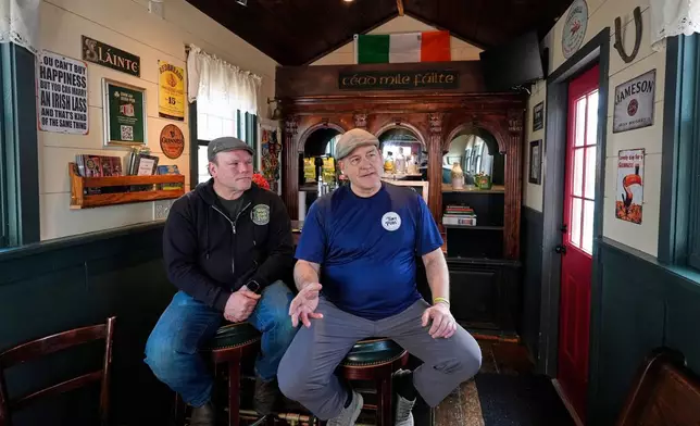 Brothers Matt Taylor, left, and Craig Taylor talk with a visitor in one of their tiny pubs Wednesday, March 11, 2026, in Reading, Mass. (AP Photo/Robert F. Bukaty)