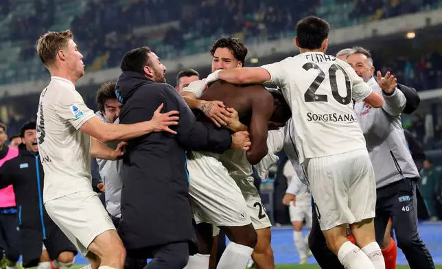Napoli's Romelu Lukaku, centre back to the camera, celebrates after scoring his side's second goal during the Serie A soccer match between Hellas Verona and Napoli in Verona, Italy, Saturday, Feb. 28, 2026. (Paola Garbuio/LaPresse via AP)