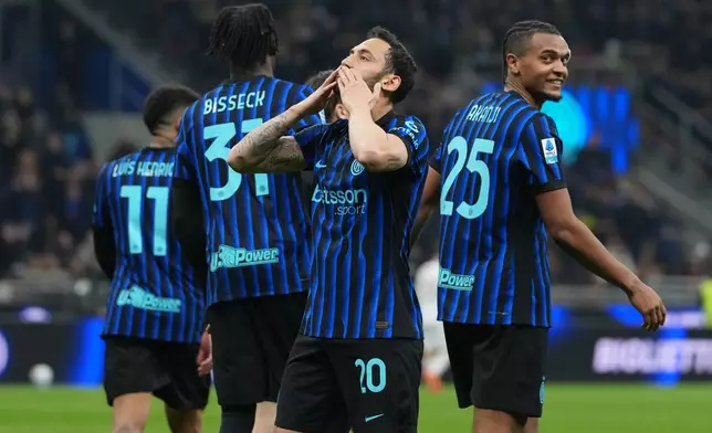 Inter Milan's Hakan Calhanoglu celebrates scoring his side's 2nd goal from the penalty spot during the Serie A soccer match between Inter Milan and Genoa in Milan, Italy, Saturday, Feb. 28, 2026. (AP Photo/Antonio Calanni)