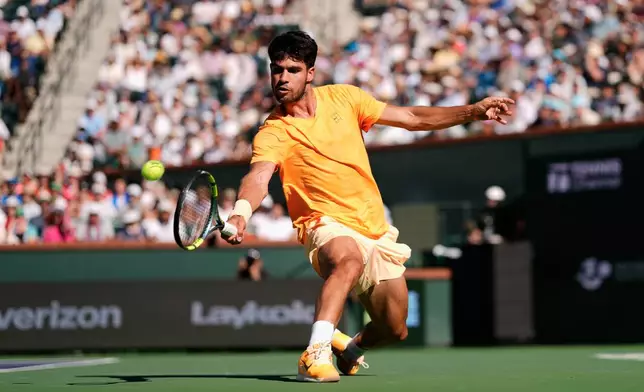 Carlos Alcaraz, of Spain, returns a shot against Daniil Medvedev, of Russia, during a semifinal match at the BNP Paribas Open tennis tournament, Saturday, March 14, 2026, in Indian Wells, Calif. (AP Photo/Mark J. Terrill)