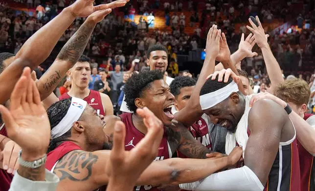 Miami Heat teammates celebrate center Bam Adebayo, right, after he scored 83 points, the second-highest single game total in NBA history, in an NBA basketball game against the Washington Wizards, Tuesday, March 10, 2026, in Miami. (AP Photo/Rebecca Blackwell)