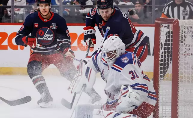 New York Rangers goaltender Igor Shesterkin (31) saves the shot from Winnipeg Jets' Cole Koepke (45) during the second period of an NHL game in Winnipeg, Thursday, March 12, 2026. (John Woods/The Canadian Press via AP)