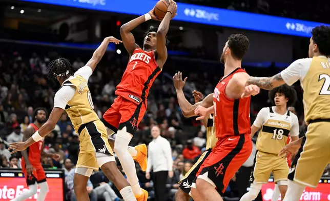 Houston Rockets guard Amen Thompson (1) goes up to shoot against Washington Wizards guard Bilal Coulibaly (0) during the first half of an NBA basketball game, Monday, March 2, 2026, in Washington. (AP Photo/John McDonnell)