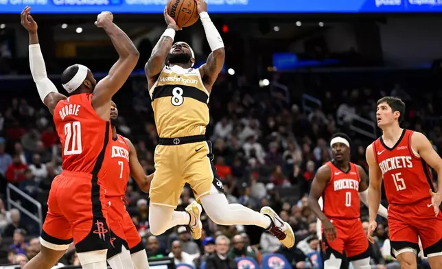 Washington Wizards guard Jaden Hardy (8) goes up to shoot against Houston Rockets guard Josh Okogie (20) during the second half of an NBA basketball game, Monday, March 2, 2026, in Washington. (AP Photo/John McDonnell)