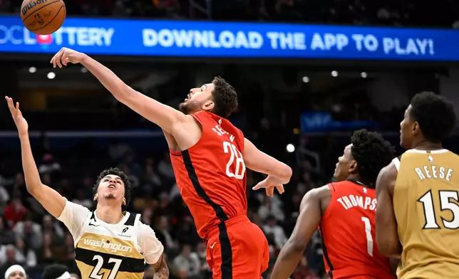 Washington Wizards guard Will Riley (27) has his shot blocked by Houston Rockets center Alperen Sengun during the second half of an NBA basketball game, Monday, March 2, 2026, in Washington. (AP Photo/John McDonnell)
