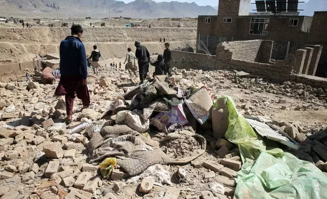 Residents inspect the site of a strike in Kabul, Afghanistan, Friday, March 13, 2026. (AP Photo/Barackatullah Popal)