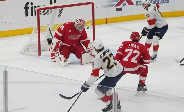 Florida Panthers center Carter Verhaeghe (23) scores a goal against Detroit Red Wings goaltender John Gibson (36) during the third period of an NHL hockey game, Tuesday, March 10, 2026, in Sunrise, Fla. (AP Photo/Marta Lavandier)