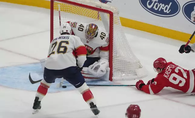 Florida Panthers goaltender Daniil Tarasov (40) stops a shot on goal by Detroit Red Wings center Marco Kasper (92) during the third period of an NHL hockey game, Tuesday, March 10, 2026, in Sunrise, Fla. (AP Photo/Marta Lavandier)