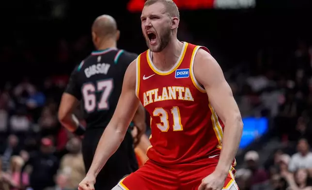 Atlanta Hawks center Jock Landale (31) celebrates his dunk against the Memphis Grizzlies during the first half of an NBA basketball game, Monday, March 23, 2026, in Atlanta. (AP Photo/Mike Stewart)