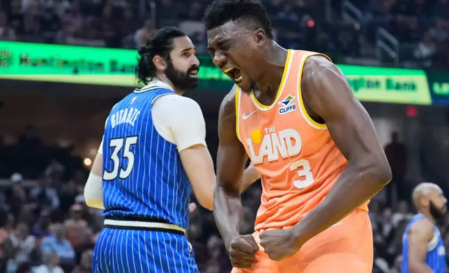 Cleveland Cavaliers center Thomas Bryant (3) shouts after dunking over Orlando Magic center Goga Bitadze (35) in the first half of an NBA basketball game in Cleveland, Tuesday, March 24, 2026. (AP Photo/Sue Ogrocki)