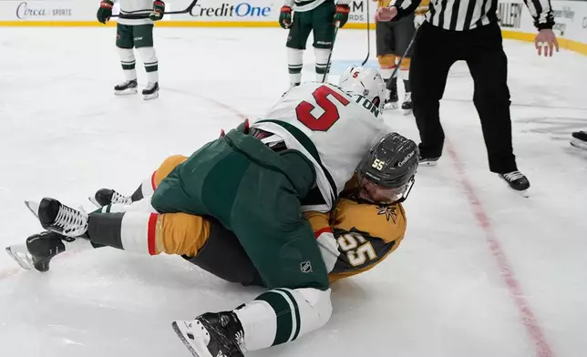 Minnesota Wild defenseman Jake Middleton, left, and Vegas Golden Knights right wing Keegan Kolesar (55) fight during the second period of an NHL hockey game Friday, March 6, 2026, in Las Vegas. (AP Photo/John Locher)