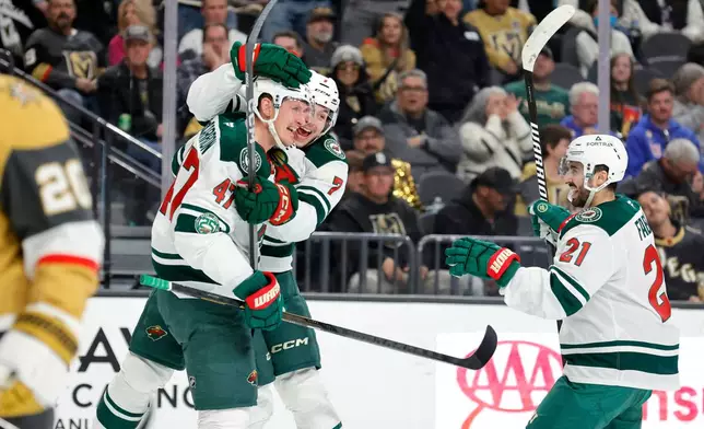 Minnesota Wild center Michael McCarron (47) celebrates with defenseman Brock Faber (7) and center Robert Fabbri (21) after scoring against the Vegas Golden Knights during the second period of an NHL hockey game, Friday, March 6, 2026, in Las Vegas. (Steve Marcus/Las Vegas Sun via AP)
