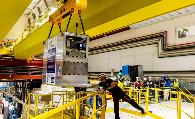Technicians move the transportable antimatter trap into the Antimatter Factory at the European Organization for Nuclear Research (CERN) for a road test in Meyrin near Geneva, Switzerland, Tuesday, March 24, 2026. (Salvatore Di Nolfi/Keystone via AP)