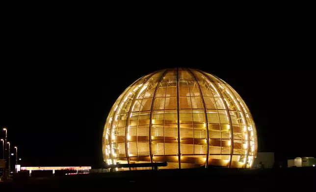 FILE - The globe of the European Organization for Nuclear Research, CERN, is illuminated outside Geneva, Switzerland, March 30, 2010. (AP Photo/Anja Niedringhaus, File)