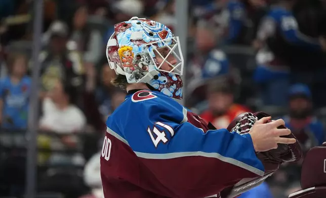Colorado Avalanche goaltender Scott Wedgewood puts on his gloves for the second period of an NHL hockey game against the Calgary Flames, Monday, March 30, 2026, in Denver. (AP Photo/David Zalubowski)