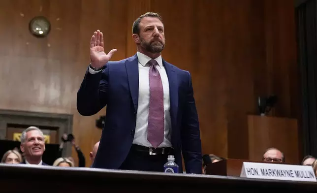 Sen. Markwayne Mullin, R-Okla., President Donald Trump's pick for Homeland Security secretary, is sworn in before testifying during Senate Committee on Homeland Security and Governmental Affairs hearing, Wednesday, March 18, 2026 on Capitol Hill in Washington. (AP Photo/Manuel Balce Ceneta)