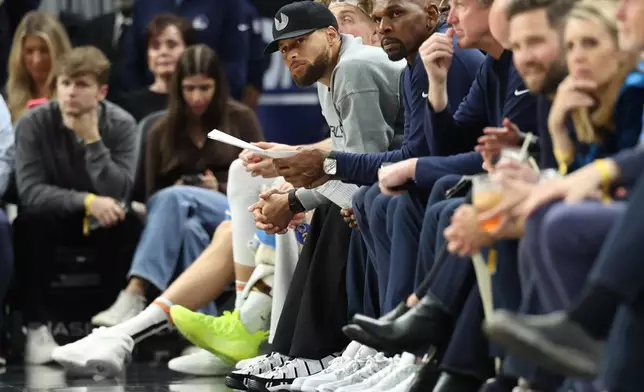 Golden State Warriors guard Stephen Curry watches from the bench during the second half of an NBA basketball game against the Brooklyn Nets in San Francisco, Wednesday, March 25, 2026. (AP Photo/Jed Jacobsohn)