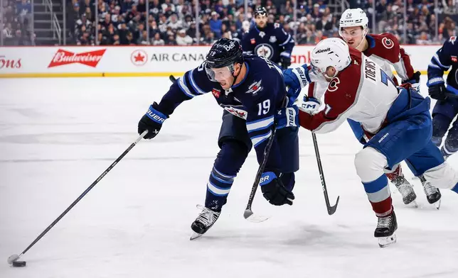 Colorado Avalanche's Devon Toews (7) defends against Winnipeg Jets' Jonathan Toews (19) during the second period of an NHL hockey game, in Winnipeg, Manitoba, Thursday, March 26, 2026. (John Woods/The Canadian Press via AP)