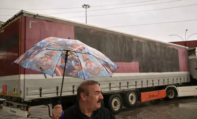 Iranian Kurdish Korban Ali stands on the Iraqi side of the Haji Omeran crossing between Iran and the autonomous Kurdistan Region of Iraq (KRI), Sunday, March 15, 2026, as the border remains open. (AP Photo/Leo Correa)