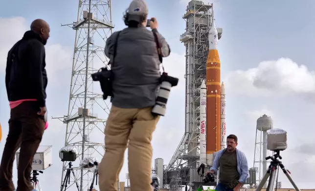 Photographers setup remote cameras near NASA's Artermis II moon rocket on Launch Pad 39-B at the Kennedy Space Center Sunday, March 29, 2026, in Cape Canaveral, Fla. (AP Photo/Chris O'Meara)