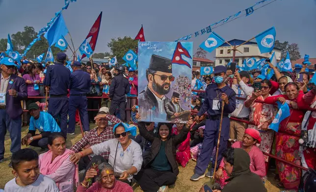 Supporters of the Rastriya Swatantra Party shout slogans as they wait for the arrival of rapper-turned-politician Balendra Shah during an election campaign rally in Chitwan, approximately 180 kilometers (112 miles) west of Kathmandu, Nepal, Friday, Feb. 27, 2026. (AP Photo/Niranjan Shrestha)